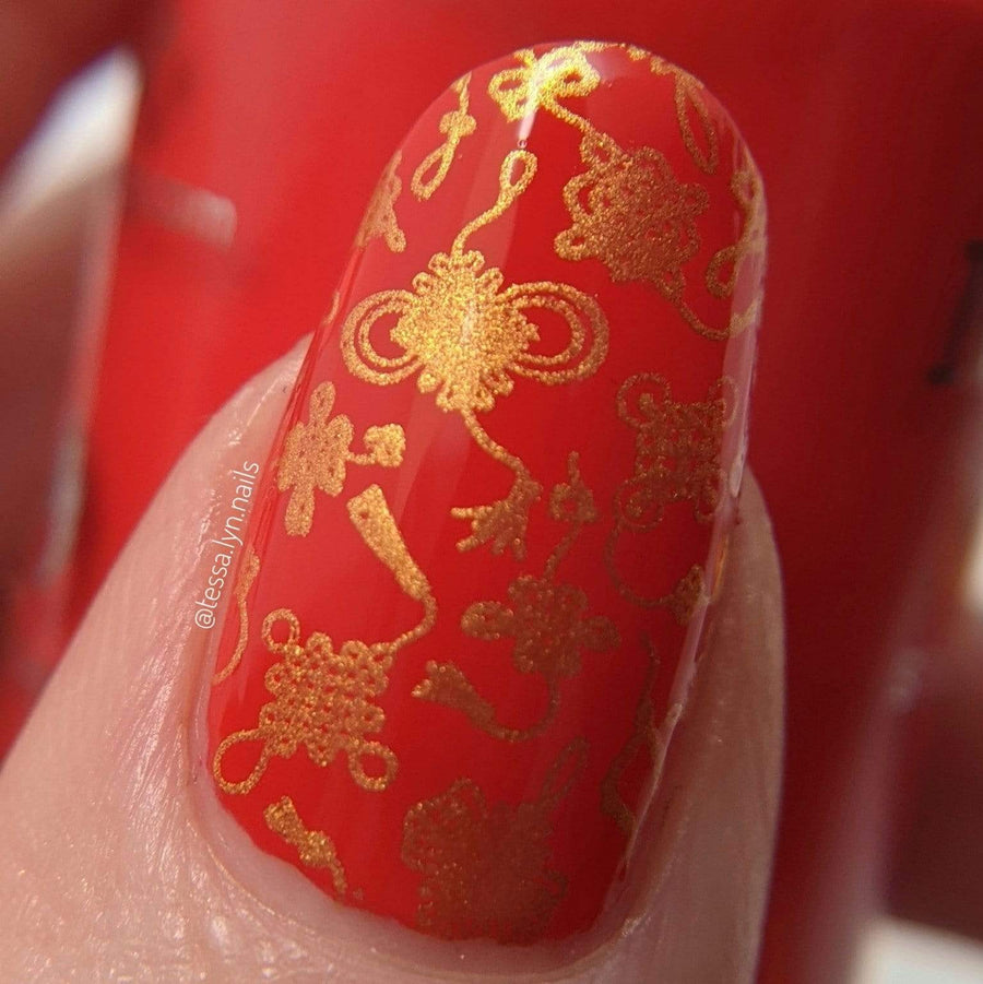 A manicured hand with Lunar New Year: Year of the Ox designs by Maniology (m185).