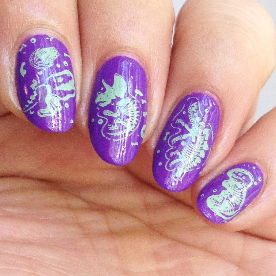 A manicured hand made with Purple Stamping Polish Littlefoot (B281) by Maniology.