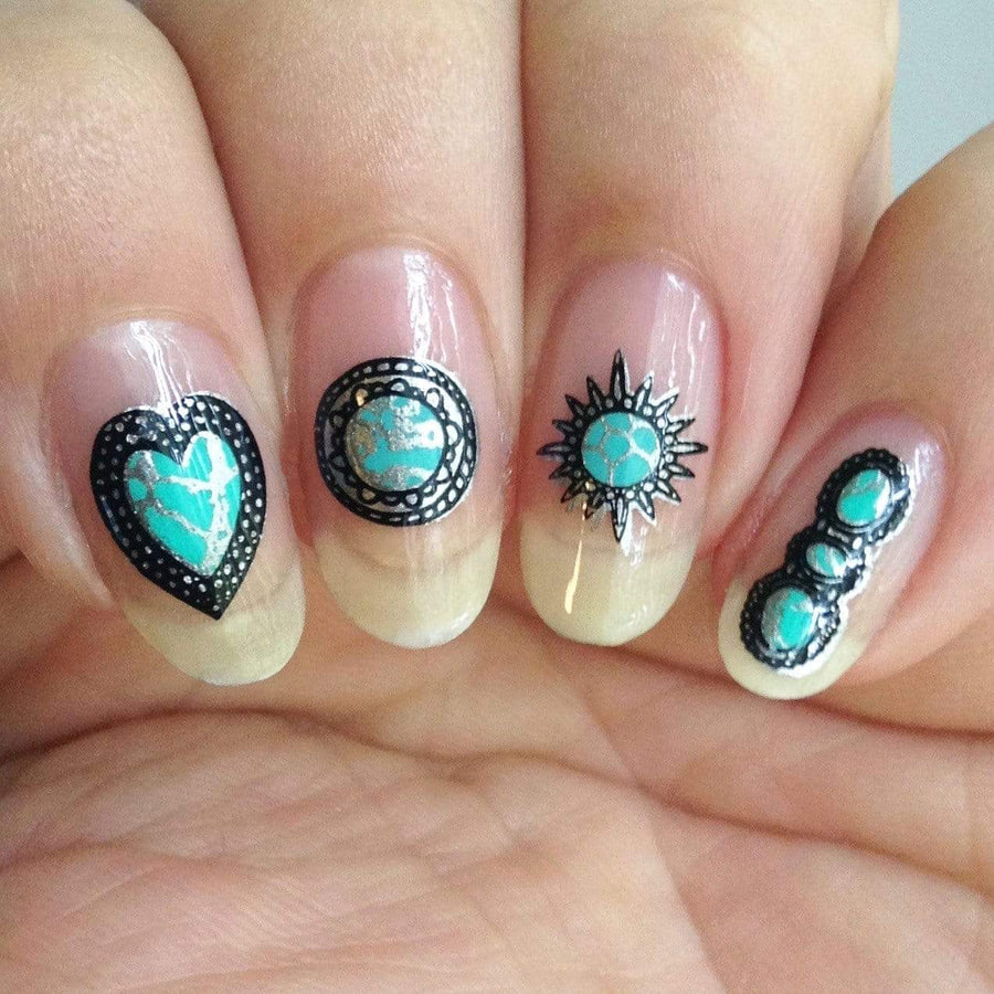 A manicured hand with heart, sun and tribal designs.