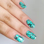 A manicured hand made with Green Stamping Polish Turquoise (B324) by Maniology.