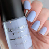 A manicured hand holding a Light Purple Stamping Polish Lilac Clouds (B238) by Maniology.