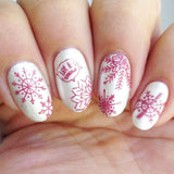 A manicured hand made with Sugarplum (B317) and Frozen (B316) stamping polishes by Maniology. 