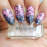 A manicured hand made with Black Magick (B293) Holographic Black Stamping Polish holding a stamper by Maniology.
