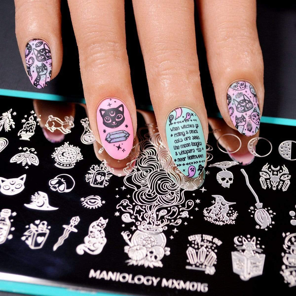 A manicured hand with cats and ghost designs made with Black Magick (B293) Stamping Polish by Maniology.