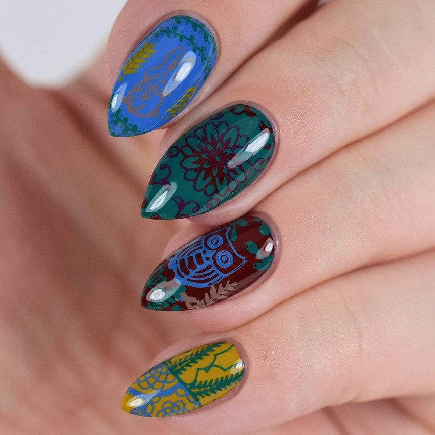 A manicured hand with flowers and owl designs.