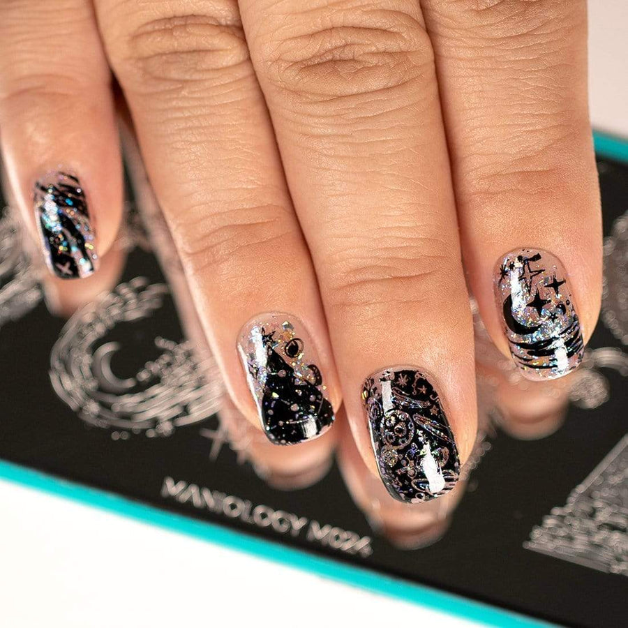  A manicured hand with Negative Space: Starry Night design by Maniology (m024) over a nail stamping plate.
