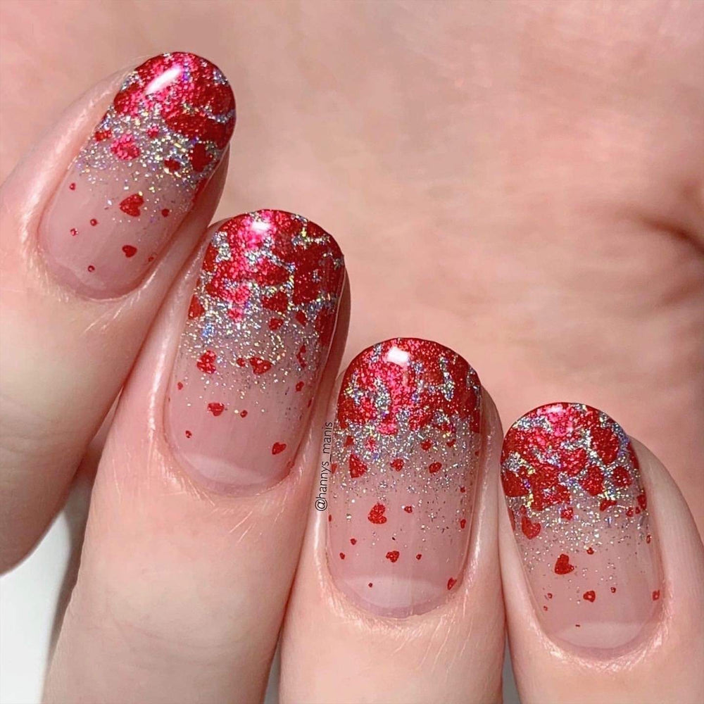 A manicured hand made with Galentine (B329) Metallic Red Stamping Polish by Maniology.