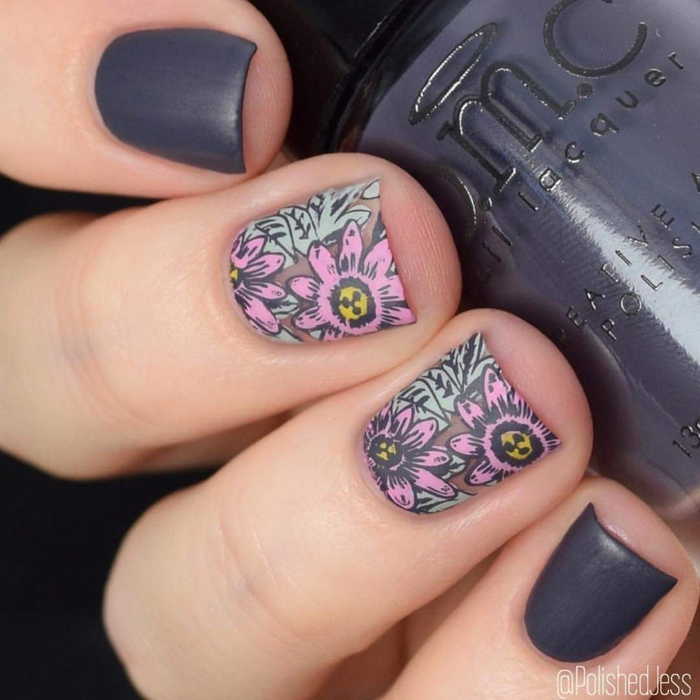A manicured hand with flowers design holding a Dark Purple Stamping Polish.