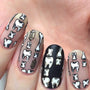 A manicured hand made with Straight Up Black (B171) and WHITE (B170) stamping polishes by Maniology.