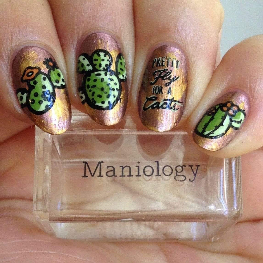  A manicured hand with different cacti designs holding a stamper.