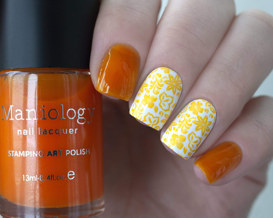 A manicured hand holding Sheer Yellow Stamping Polish from Rainbow Splash Collection: Sunny Day (B271) by Maniology.