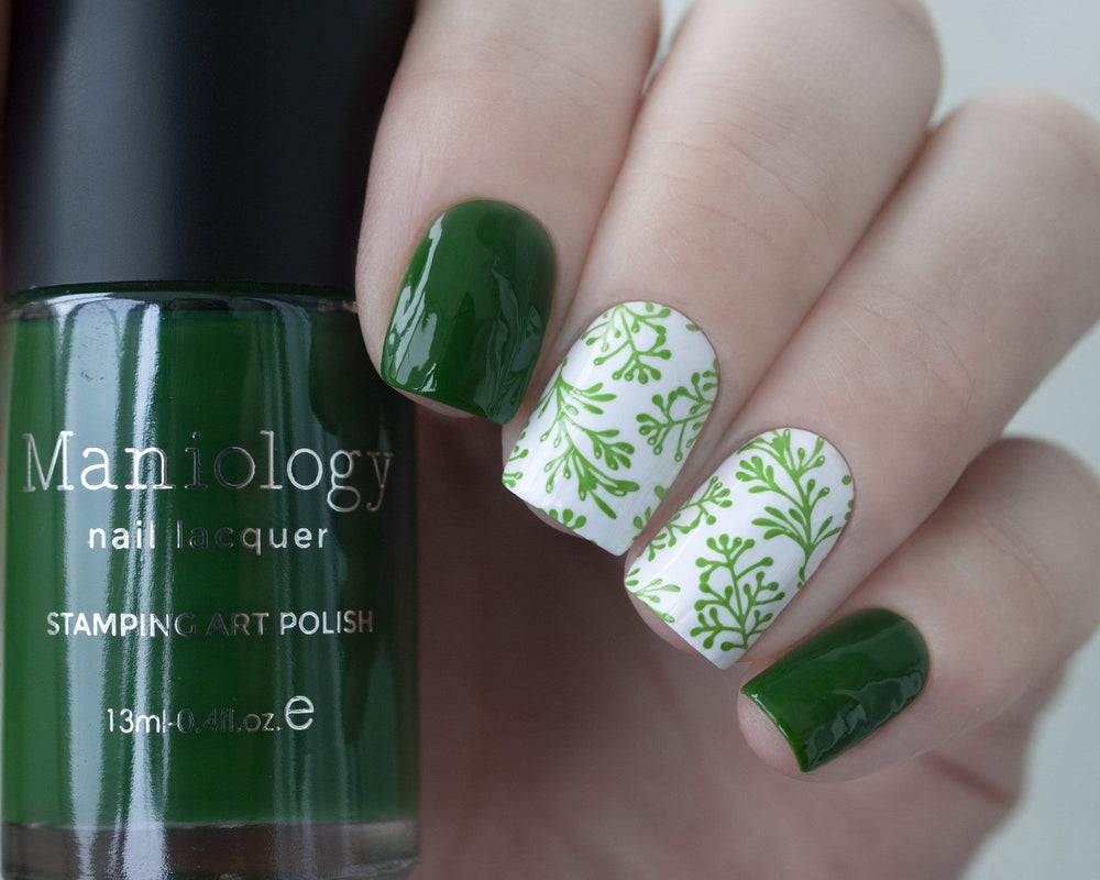 A manicured hand holding Sheer Green Stamping Polish from Rainbow Splash Collection: Garden Gnome (B275).