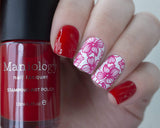A manicured hand holding Sheer Red Stamping Polish from Rainbow Splash Collection: Poppyseed (B272) by Maniology.