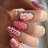 A manicured hand with Ribbons of Hope designs by Maniology (m153).