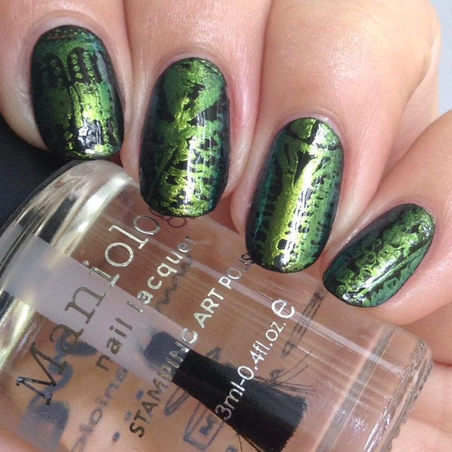 A manicured hand made with Scarab Wings Golden Green Duochrome Nail Art Powder holding a top coat by Maniology.