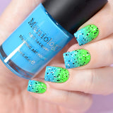 A manicured hand holding Neon Blue Stamping Polish from School's Outcollection Blue Glue (B288).