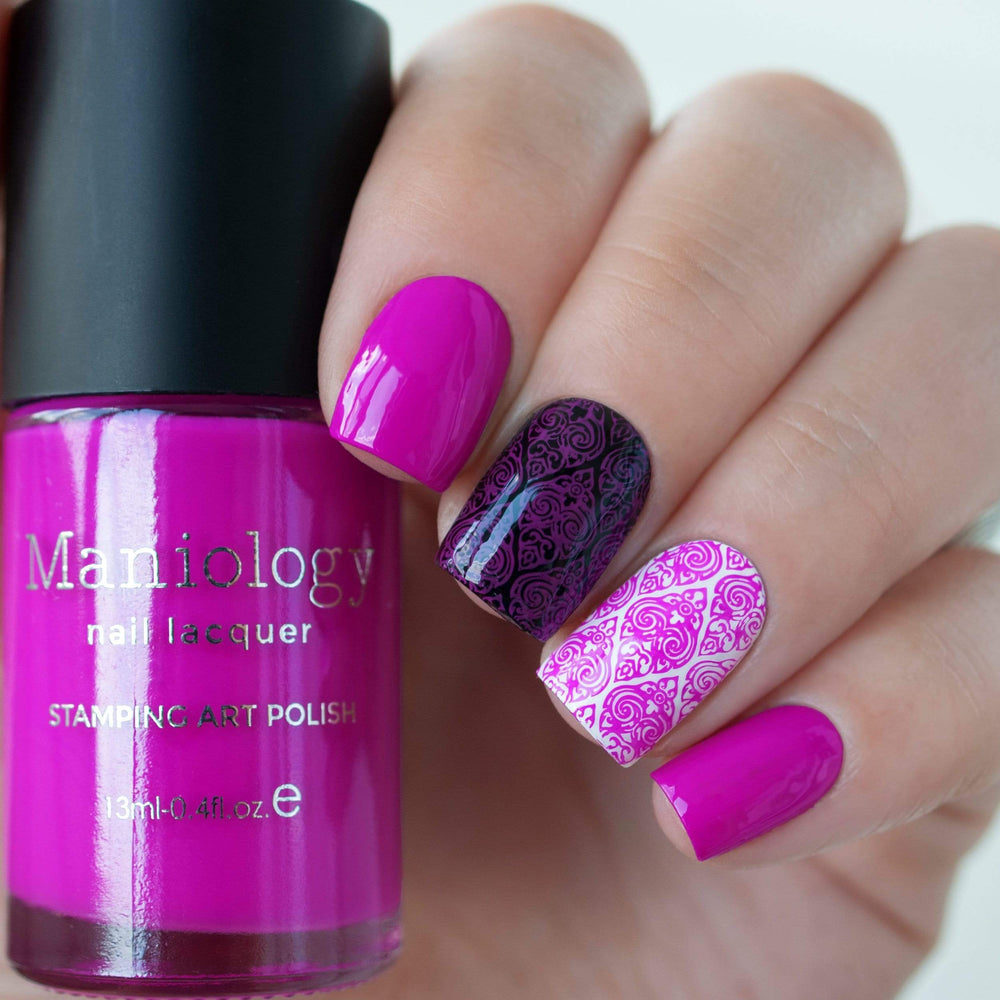 A manicured hand holding Neon Purple Stamping Polish from School's Out collection Class Clown (B289).