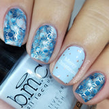 A manicured hand holding a Light Blue cream Stamping Polish.