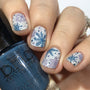  A manicured hand holding a Deep Teal Cream Stamping Polish