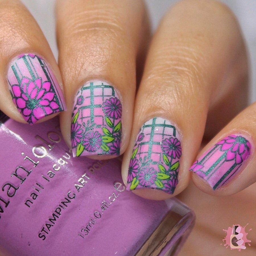 A manicured hand in purple with blooming flowers design from Spring Occasions collections holding a stamping polish by Maniology (m118)