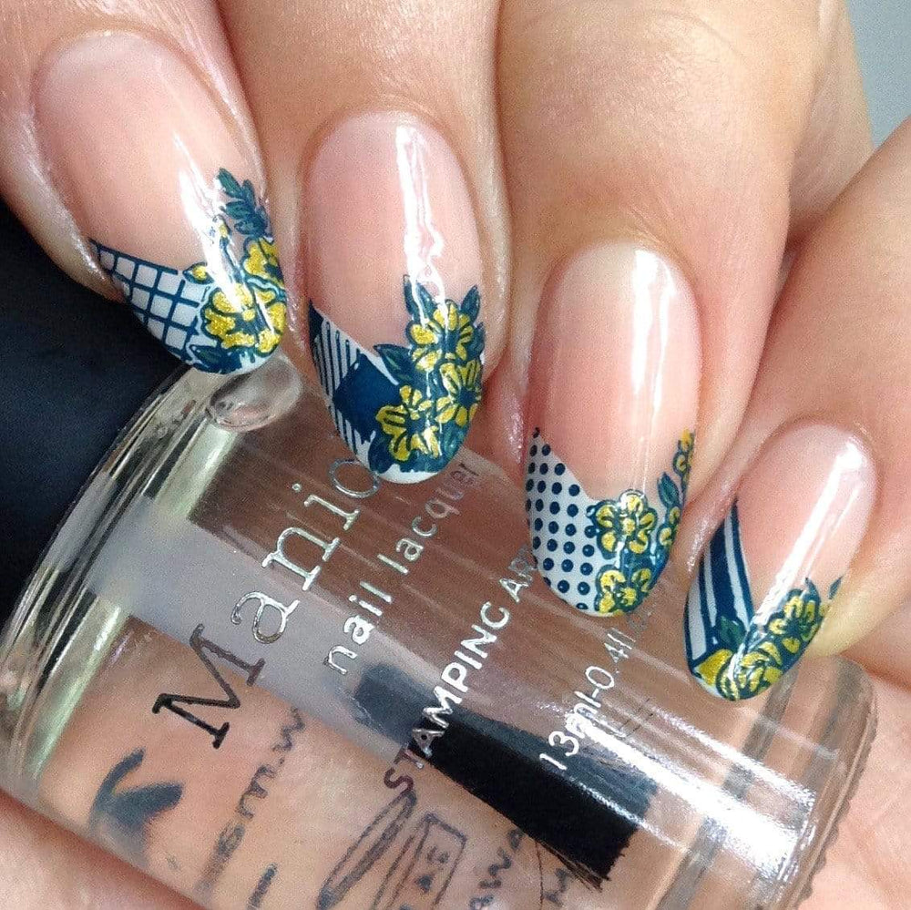 A manicured hand with blooming flowers design from Spring Occasions collections  holding a top coat by Maniology (m118)