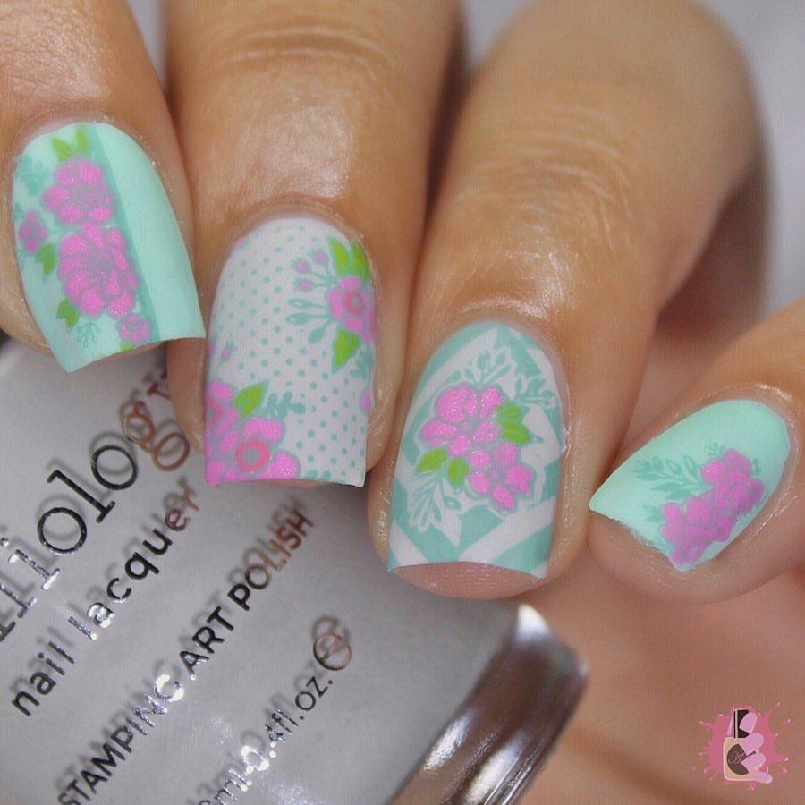 A manicured hand with blooming flowers design from Spring Occasions collections holding a stamping polish by Maniology (m118)