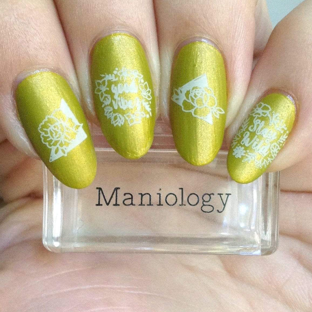 A manicured hand with blooming flowers design from Spring Occasions collections holding a stamper by Maniology (m118)