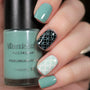 A manicured hand holding Dusty Blue Stamping Polish from Stocking Stuffer collection Morning Snow (B312).