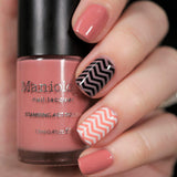 A manicured hand holding Blush Pink Stamping Polish from Stocking Stuffer: Cinnablush (B313).