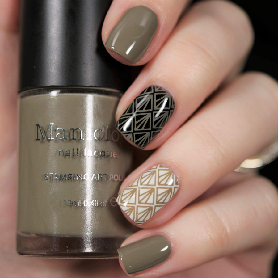  A manicured hand holding Taupe Stamping Polish from Stocking Stuffer collection Down the Chimney (B311).