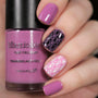 A manicured hand holding Dusty Purple Stamping Polish from Stocking Stuffer collection Sweet Berry (B310).