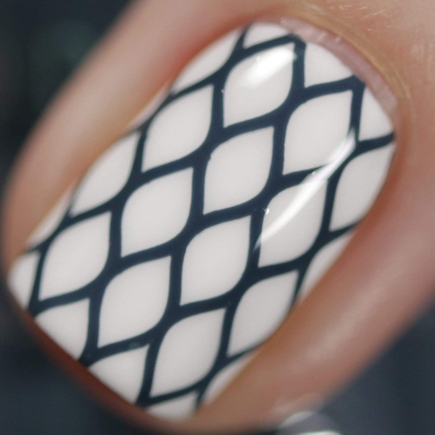 A manicured hand made with Navy Blue Stamping Polish from Stocking Stuffer collection Winter's Kiss (B314).