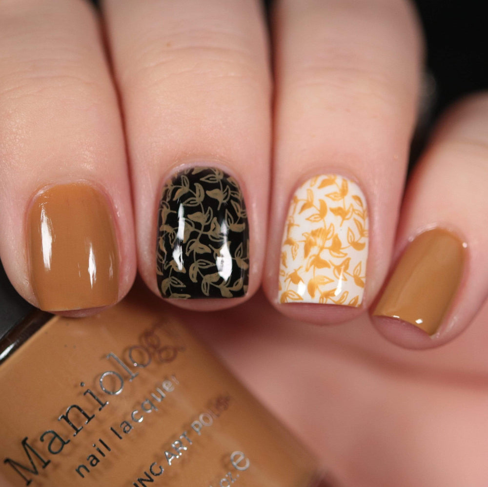 A manicured hand made with Sugar + Spice: Caramel holding a polish by Maniology (B353).