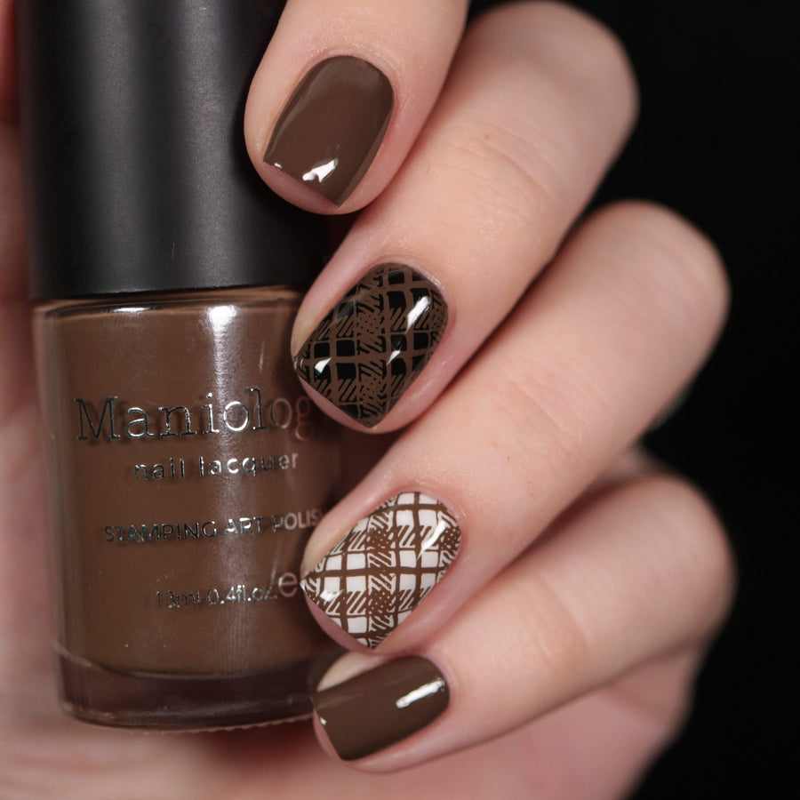 A manicured hand made with warm chocolate brown from Sugar + Spice collection holding a polish by Maniology (B351).