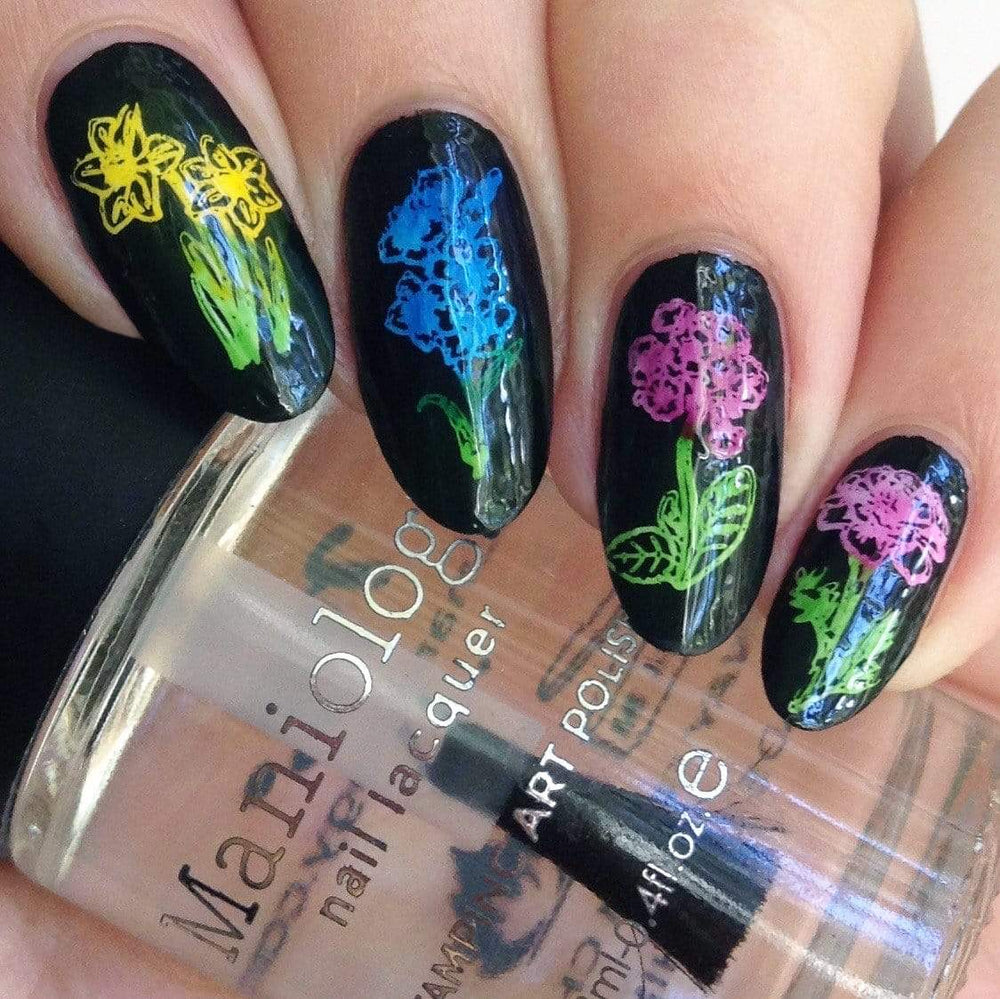 A manicured hand with flowers design holding a stamping polish by Maniology (m178).