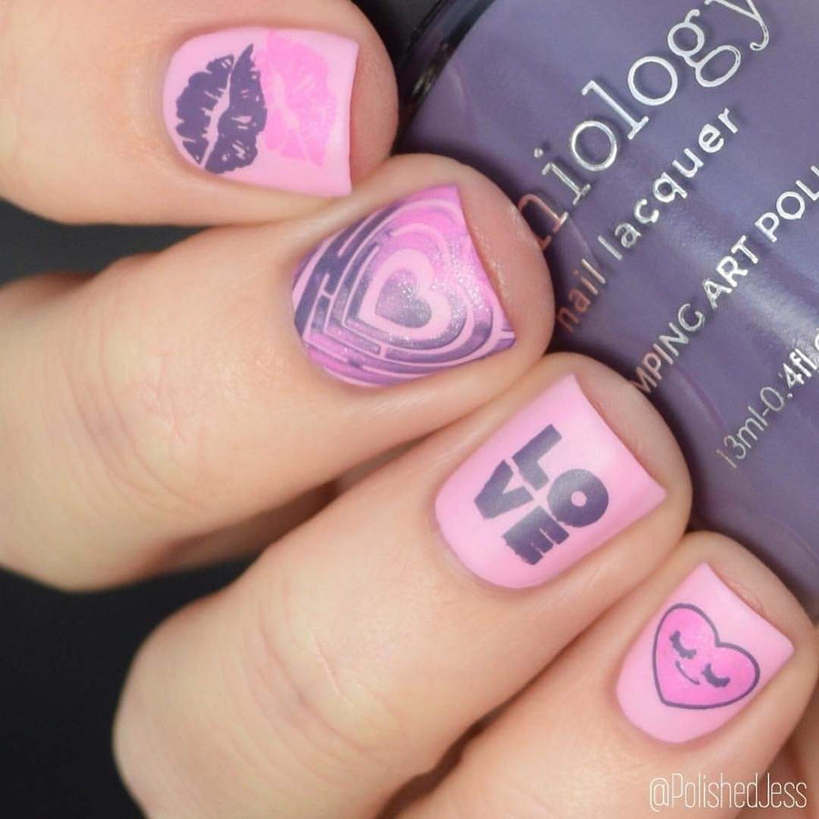 A manicured hand in pink with Valentine's Day Occasions: Opposites Attract designs holding a polish by Maniology (m045).