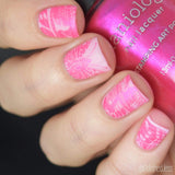  A manicured hand holding Wild Wings (B294) Hot Pink Duochrome Stamping Polish by Maniology.