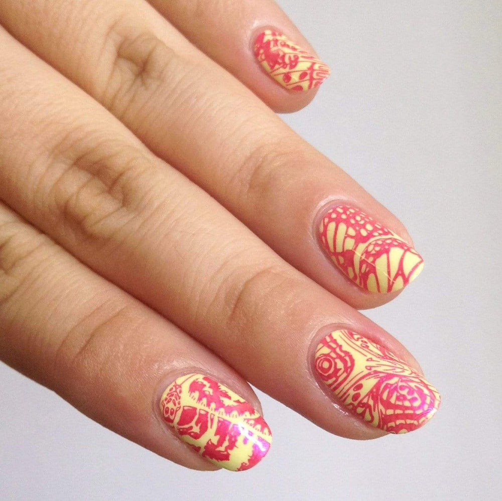 A manicured hand made with Hot Pink Duochrome Stamping Polish by Maniology.