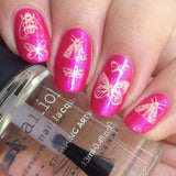 A manicured hand made with Hot Pink Duochrome Stamping Polish holding a top coat.