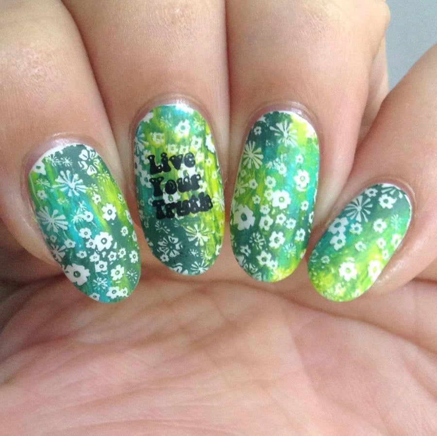 A manicured hand in green and white with a floral pattern design by Maniology.